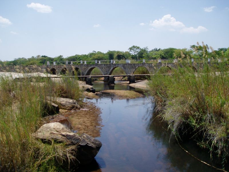 View upstream (eastwards) towards the bridge. The old low-level bridge is visible in front.